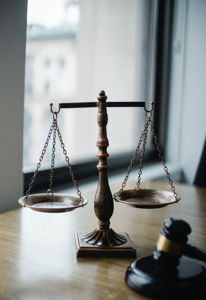 A wooden judge's gavel and scale symbolizing the legal proceedings in the bail bond process